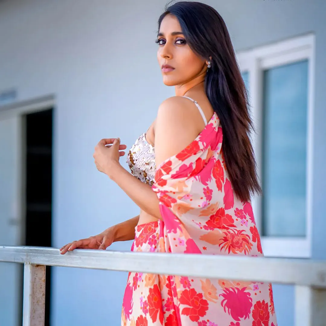 Rashmi blooms in a white and pink dress
