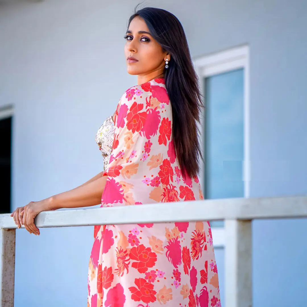 Rashmi blooms in a white and pink dress